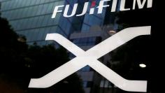 FILE PHOTO: Fujifilm's company logo (top) is seen at its exhibition hall nearby the headquarters of Fujifilm Holdings Corp in Tokyo, Japan June 12, 2017. REUTERS/Kim Kyung-Hoon/File Photo