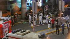 Forensic experts work outside Turkey's largest airport, Istanbul Ataturk, Turkey, following a blast