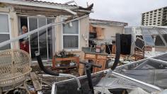 Homeowner Joe Lovece surveys the damage to the kitchen at the back of his oceanfront home after the eye of Hurricane Matthew passed Ormond Beach