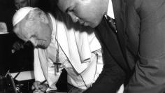POPE AND BOXER MUHAMMAD ALI EXCHANGE AUTOGRAPHS AT THE VATICAN.