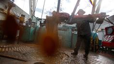 		<p>A mixture of oil, diesel fuel, water and mud sprays as roughnecks wrestle pipe on a True Company oil drilling rig outside Watford, North Dakota, October 20, 2012.</p>