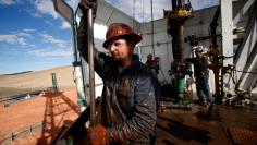 		<p>Roughneck Brian Waldner is covered in mud and oil while wrestling pipe on a True Company oil drilling rig outside Watford, North Dakota, October 20, 2012.  </p>