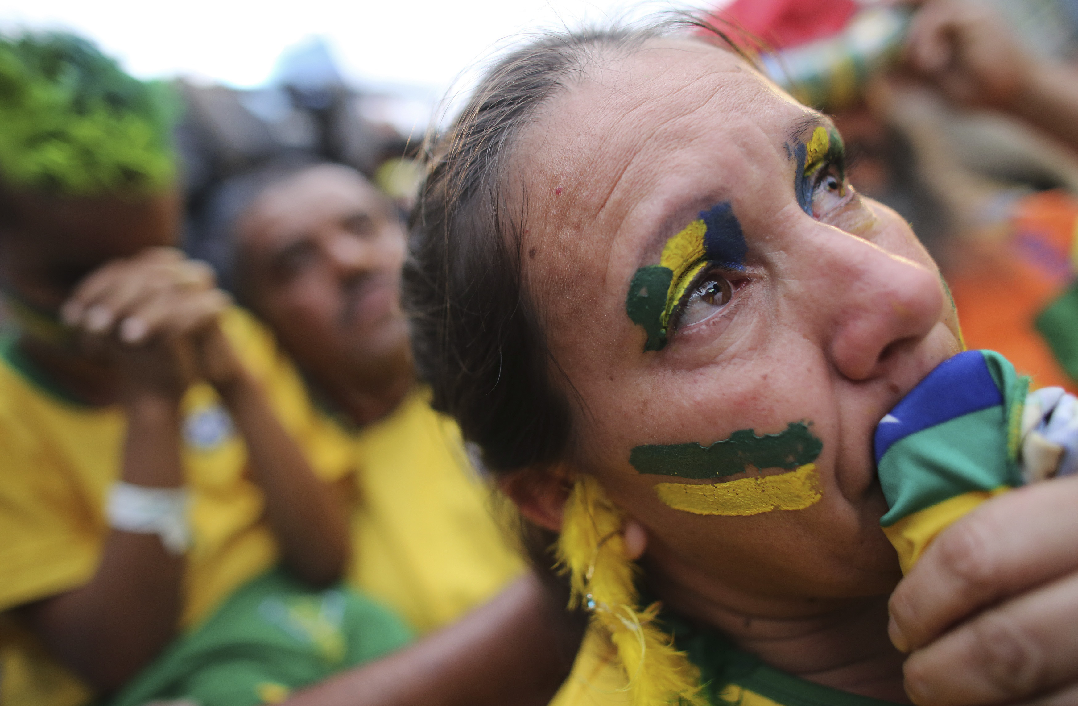 A Brazilian soccer fan cries as she watches the 2014 World Cup semi- final soccer match between Brazil and Germany in Sao Paulo 