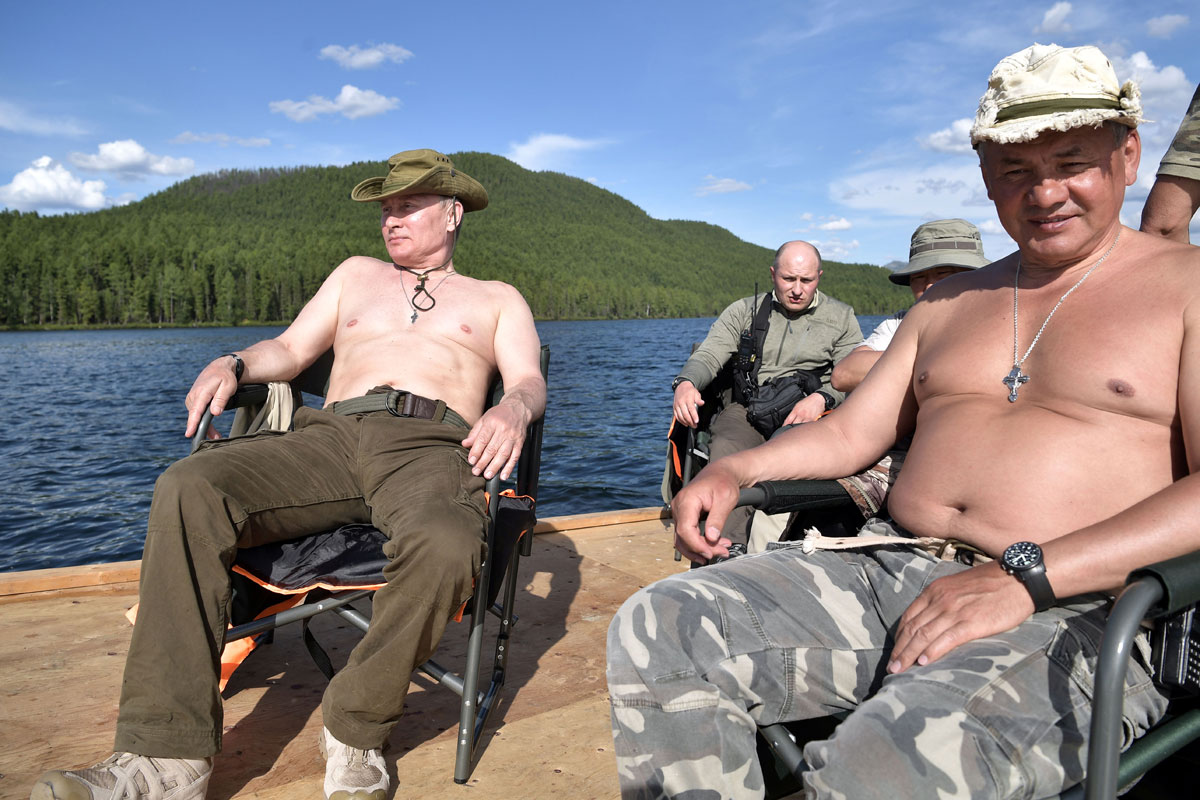 Russian President Vladimir Putin and Defence Minister Sergei Shoigu rest during the hunting and fishing trip which took place on August 1-3 in the republic of Tyva in southern Siberia