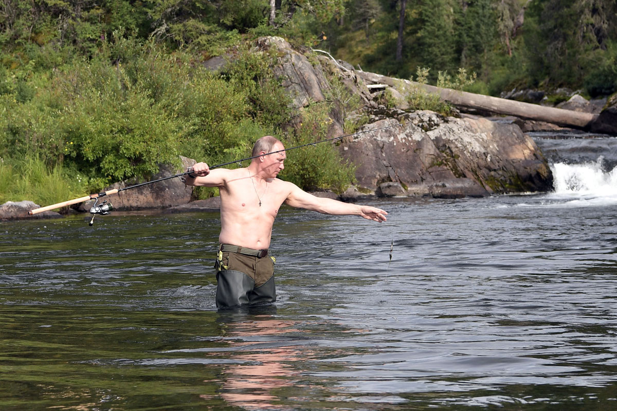 Russian President Vladimir Putin fishes during the hunting and fishing trip which took place on August 1-3 in the republic of Tyva in southern Siberia