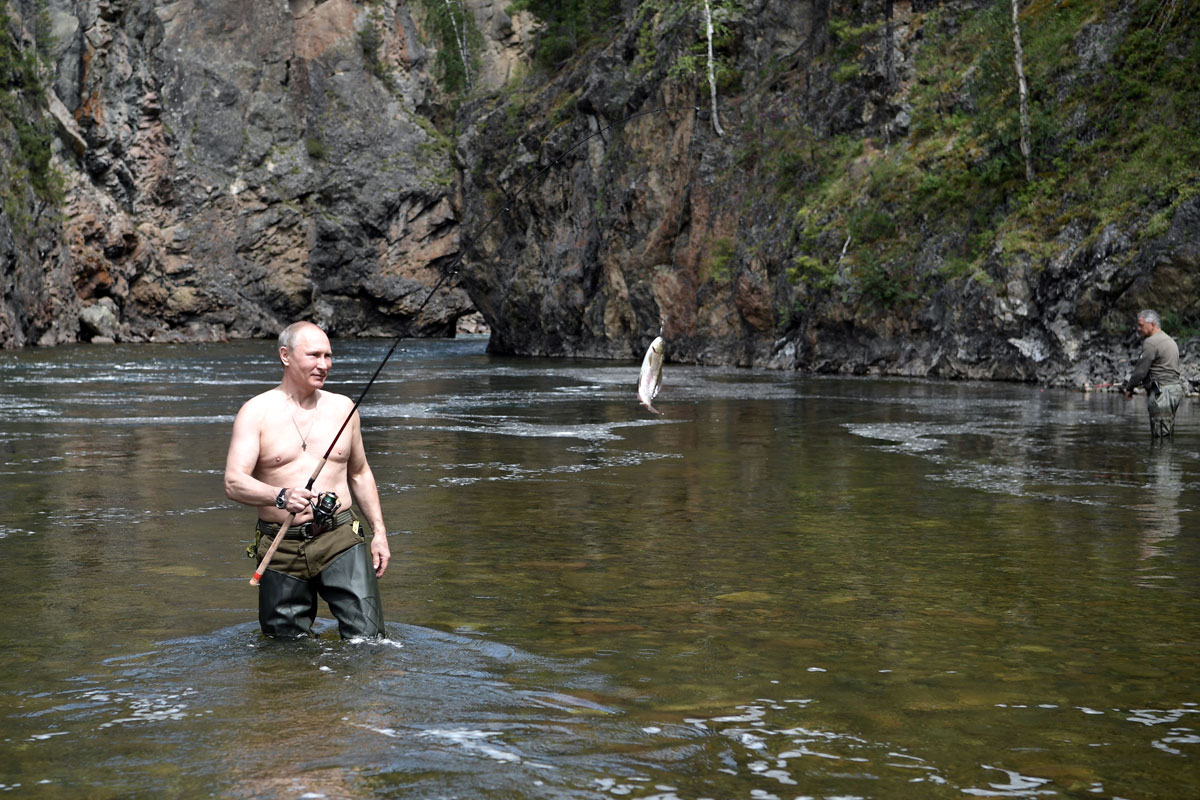 Russian President Vladimir Putin catches a fish during the hunting and fishing trip which took place on August 1-3 in the republic of Tyva in southern Siberia