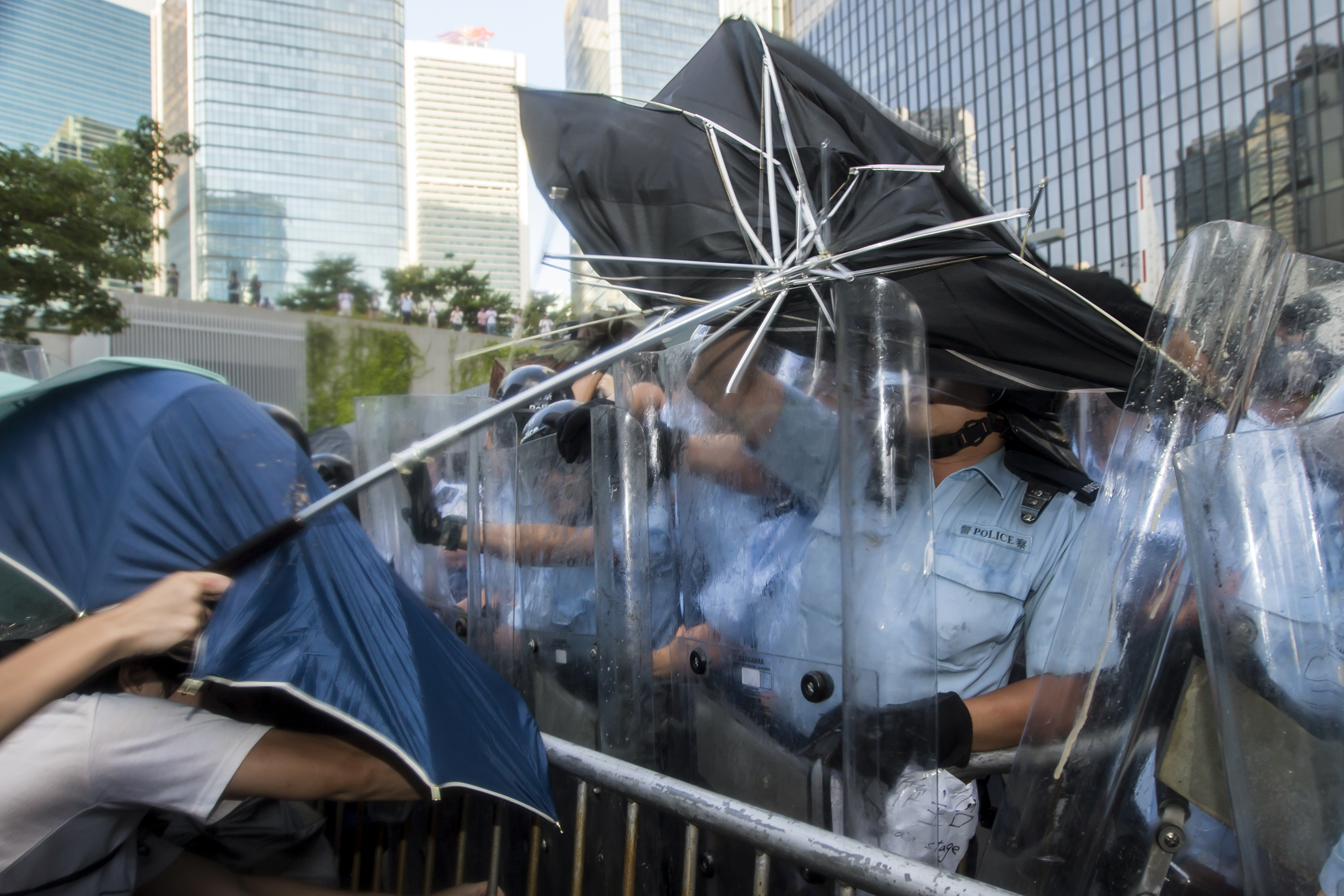 Pro-democracy students scuffle with riot police after hundreds of protesters stormed into a restricted area at the government headquarters, after a rally in Hong Kong