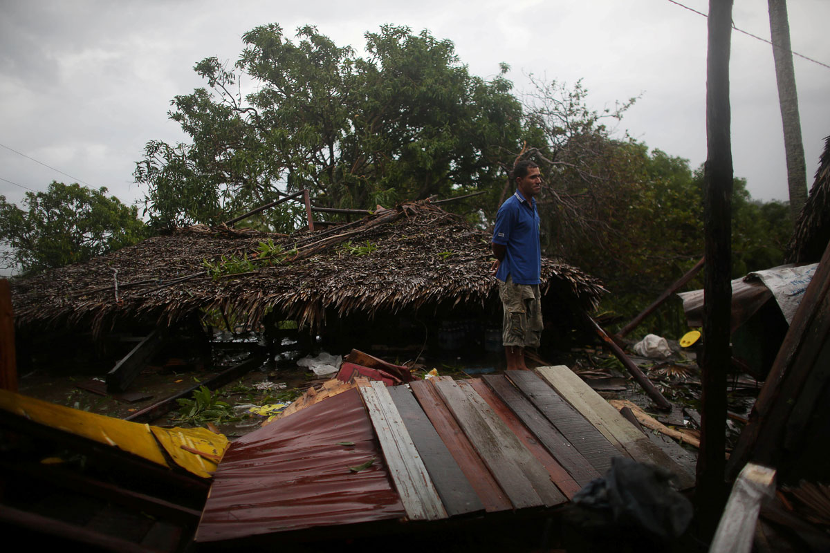 Fisherman Eneides Soares, 41, stands next to his destroyed house after the passage of Hurricane Matthew in Carbonera, Cuba