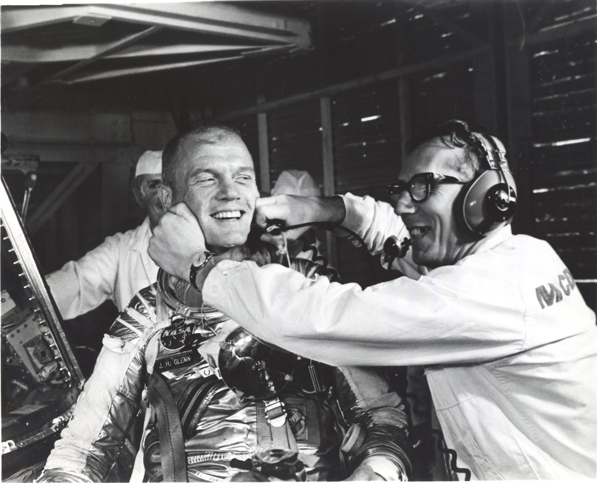 Guenter Wendt coaxes a smile out of astronaut John Glenn after the MA-6 mission was scrubbed in Cape Canaveral