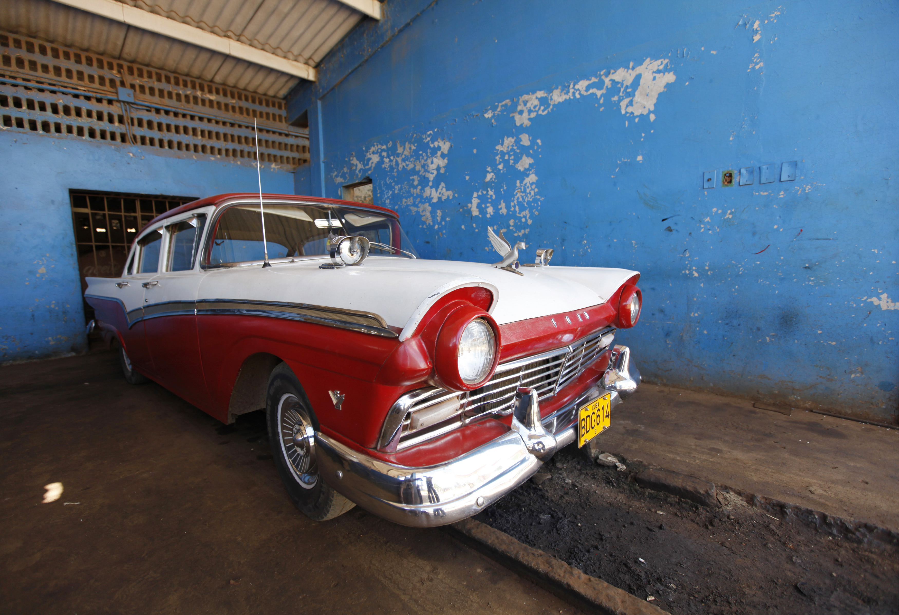 A Ford Motor Company 1954 V8 model car is parked in a garage in the village of Quivican