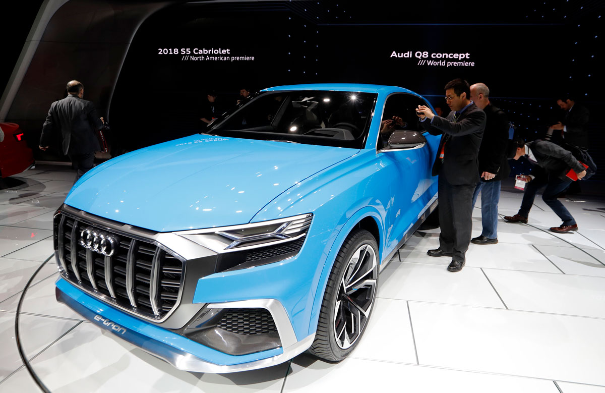 Journalists look over the Audi Q8 concept car as it is introduced during the North American International Auto Show in Detroit