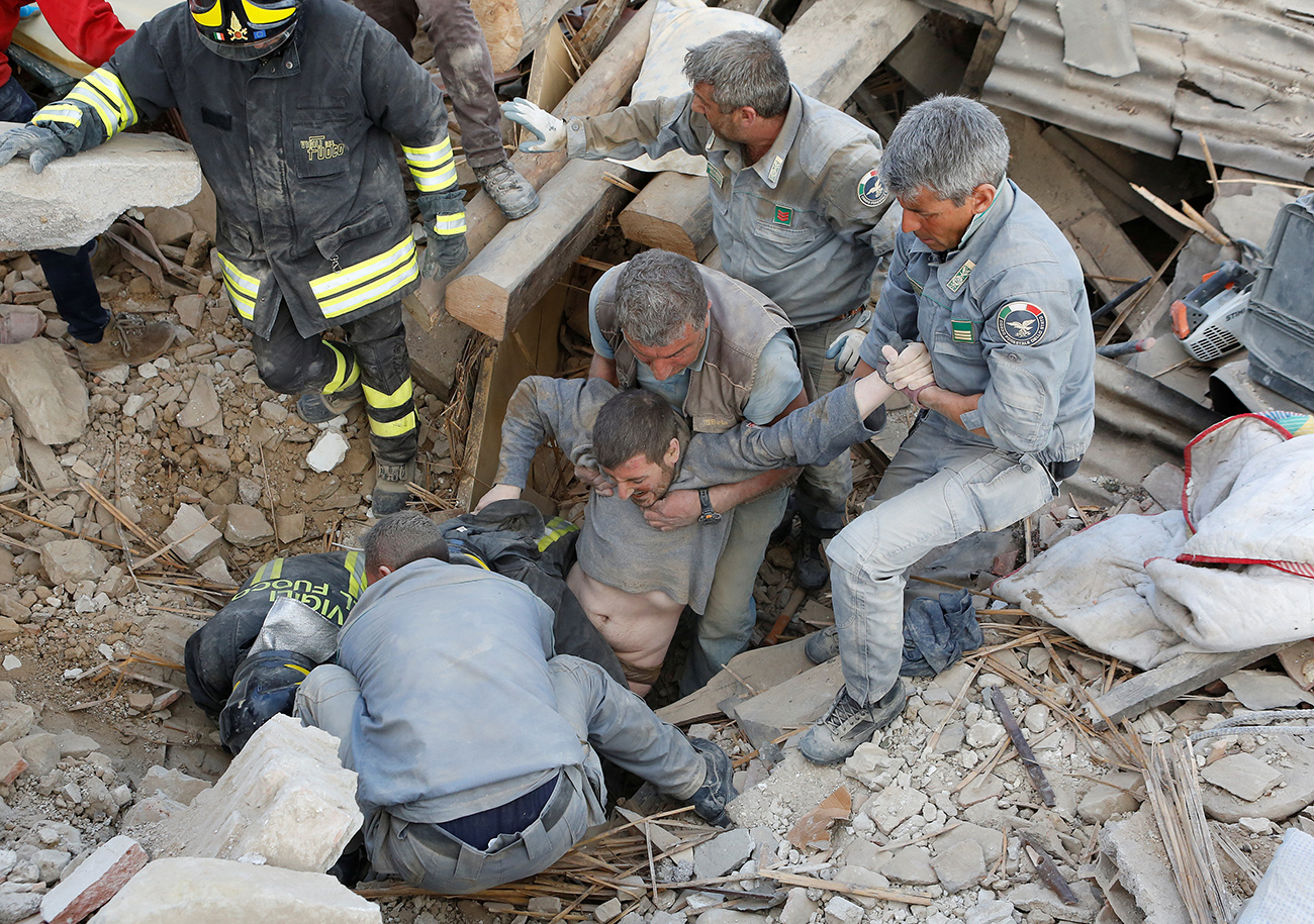 A man is rescued alive from the ruins following an earthquake in Amatrice