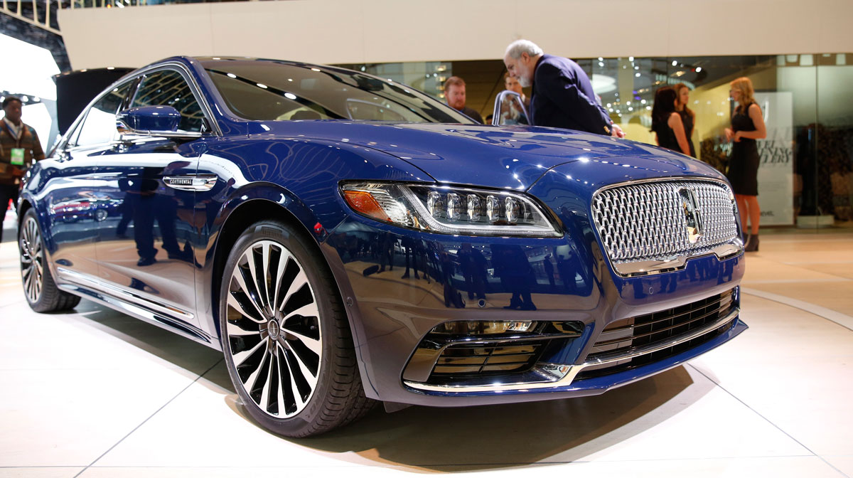 Show attendees look over a 2017 Lincoln Continental after the model was introduced at the North American International Auto Show in Detroit