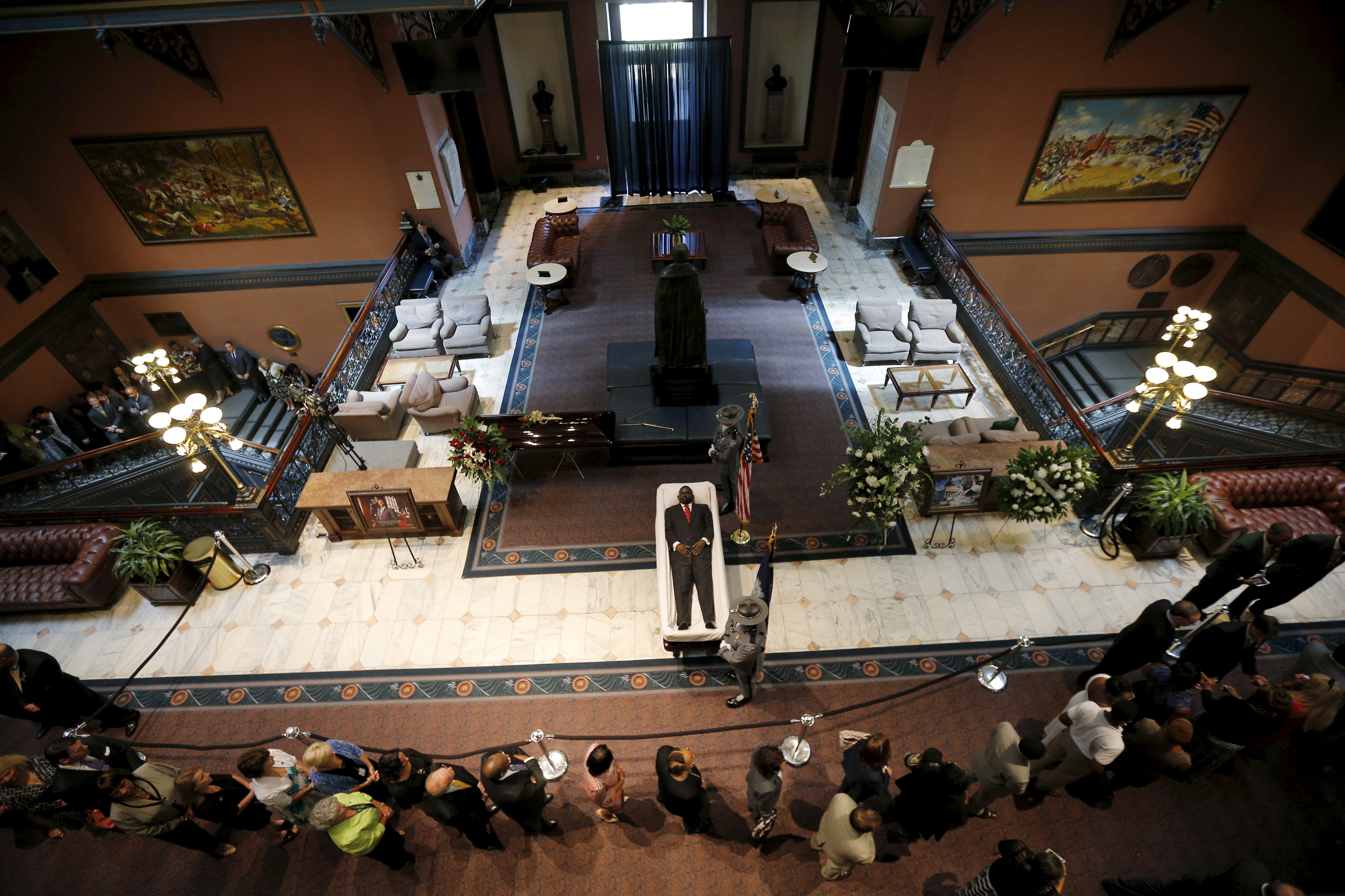 Mourners pay their respects at the casket of the late South Carolina State Senator Clementa Pinckney as he lies in state inside the rotunda of the State Capitol in Columbia
