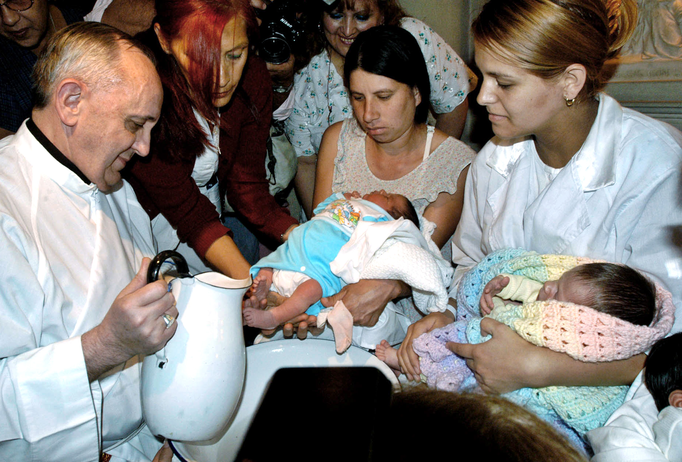 Cardinal Bergoglio Washes the Feet of Two Newborns 