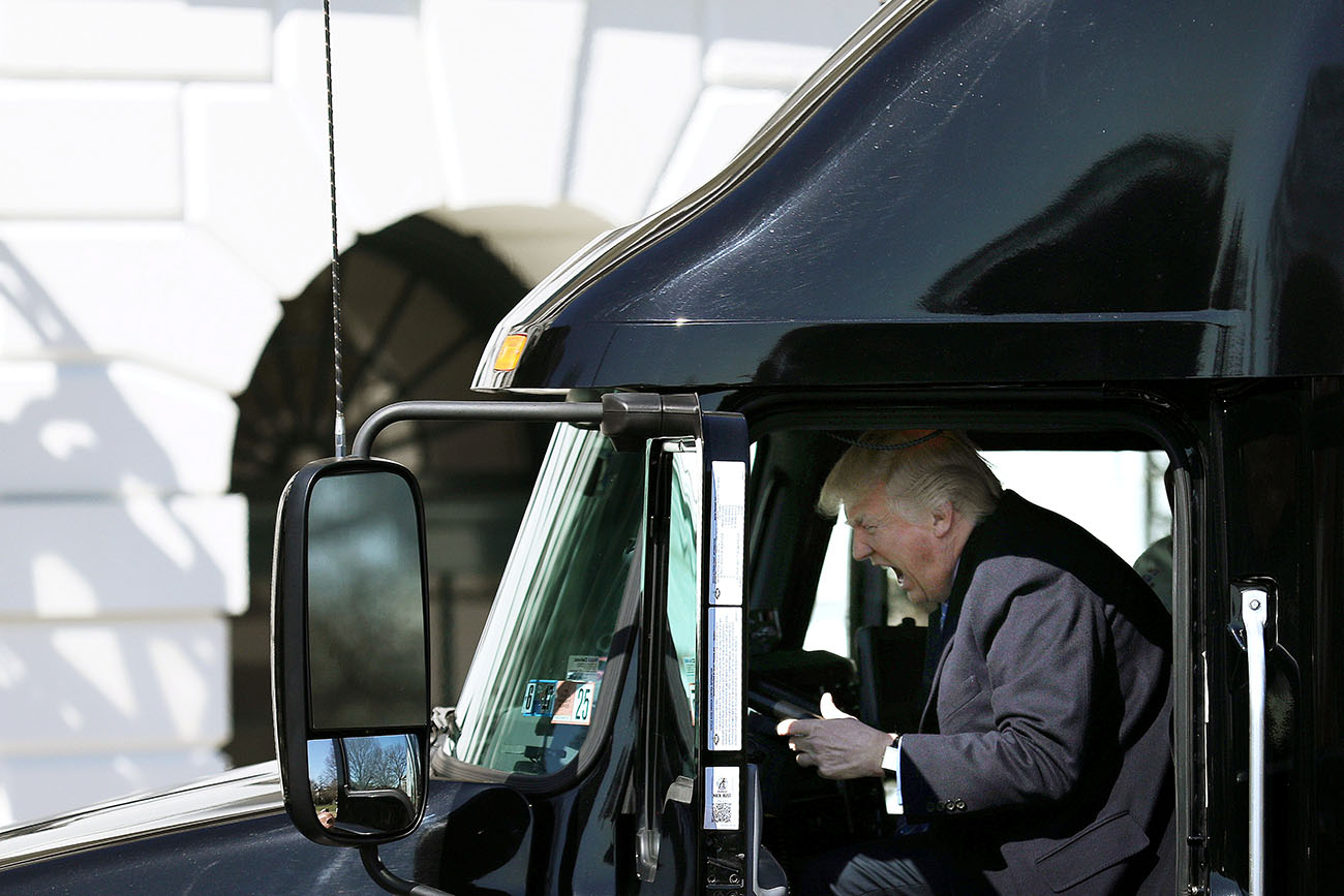 U.S. President Donald Trump reacts as he sits on a truck while he welcomes truckers and CEOs to attend a meeting regarding healthcare at the White House in Washington, U.S.