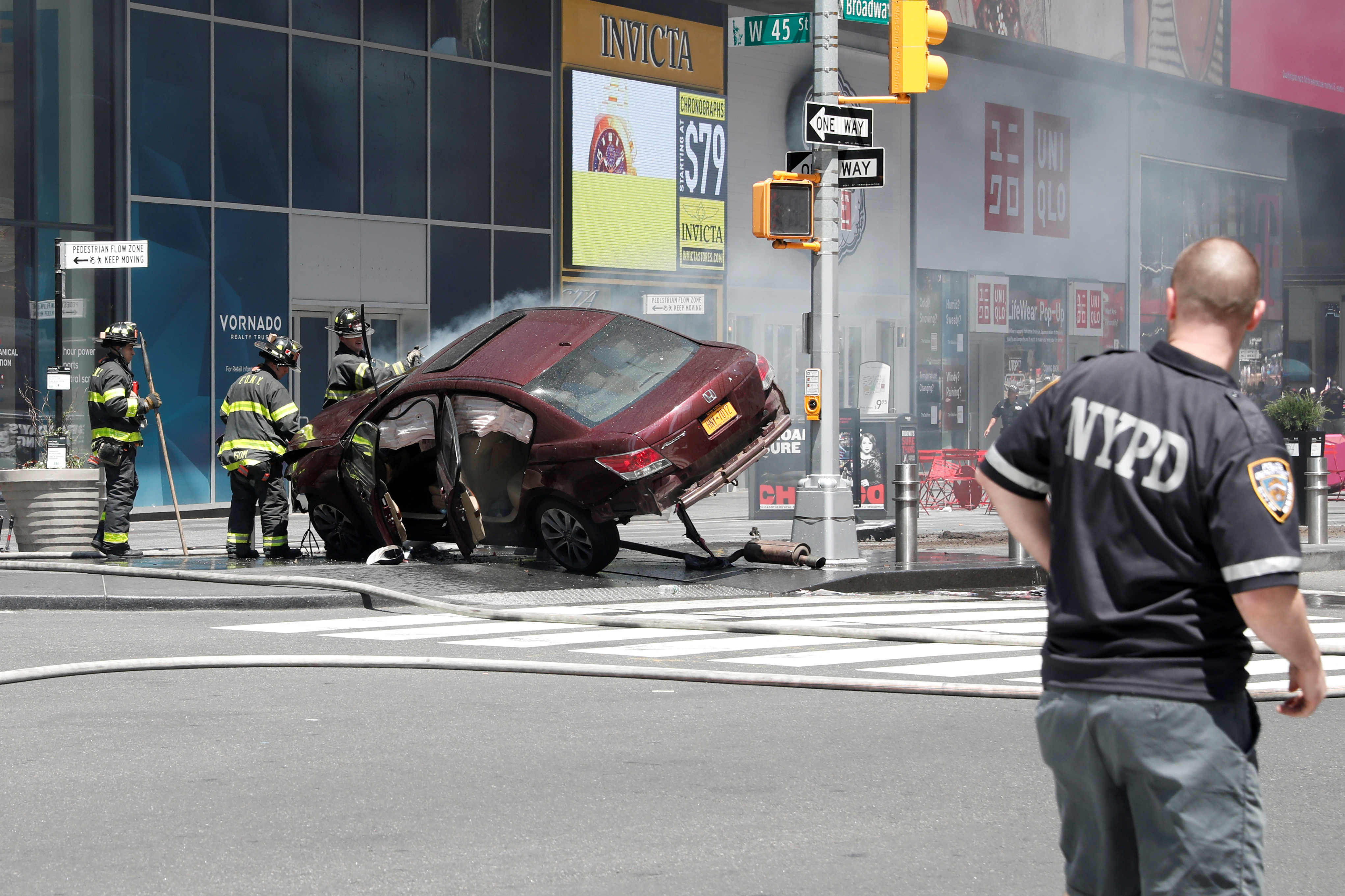 A vehicle that struck pedestrians in Times Square and later crashed is seen on the sidewalk in New York City