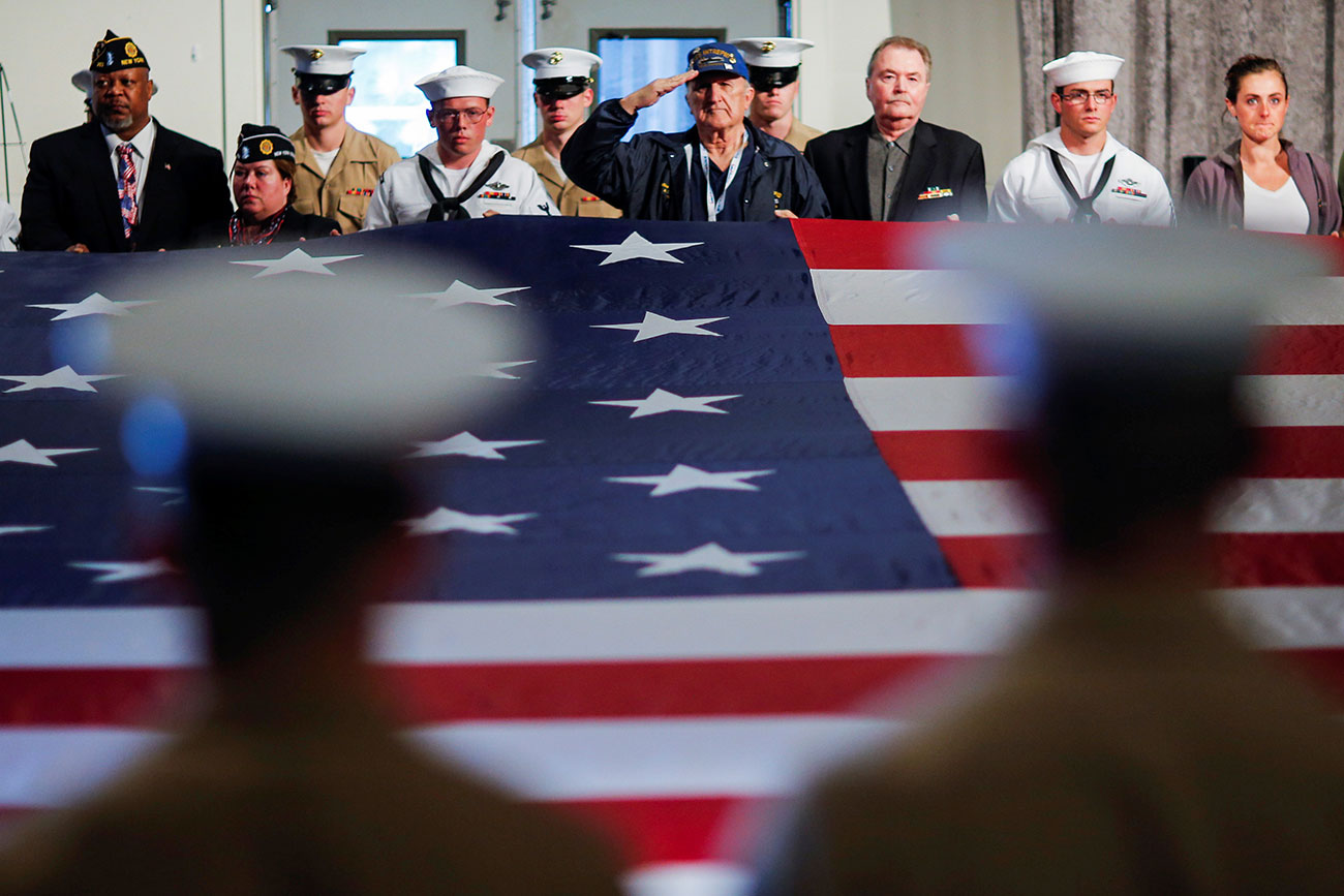 Army members hold the U.S. flag as they attend an annual Memorial Day commemoration ceremony in New York