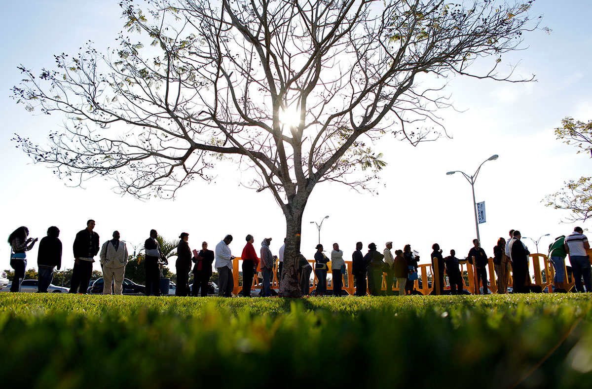 People wait in line looking for jobs during a Job Fair at the Miami Dade College in Miami, Florida
