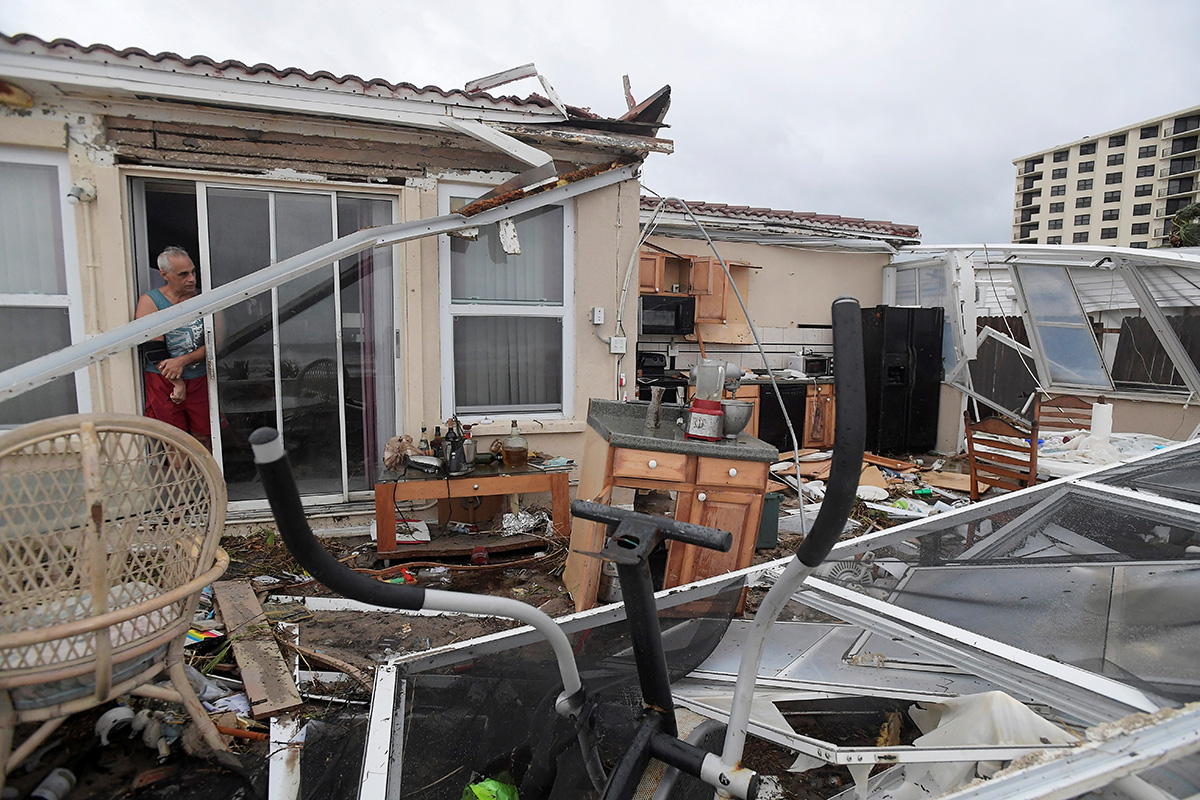 Homeowner Joe Lovece surveys the damage to the kitchen at the back of his oceanfront home after the eye of Hurricane Matthew passed Ormond Beach