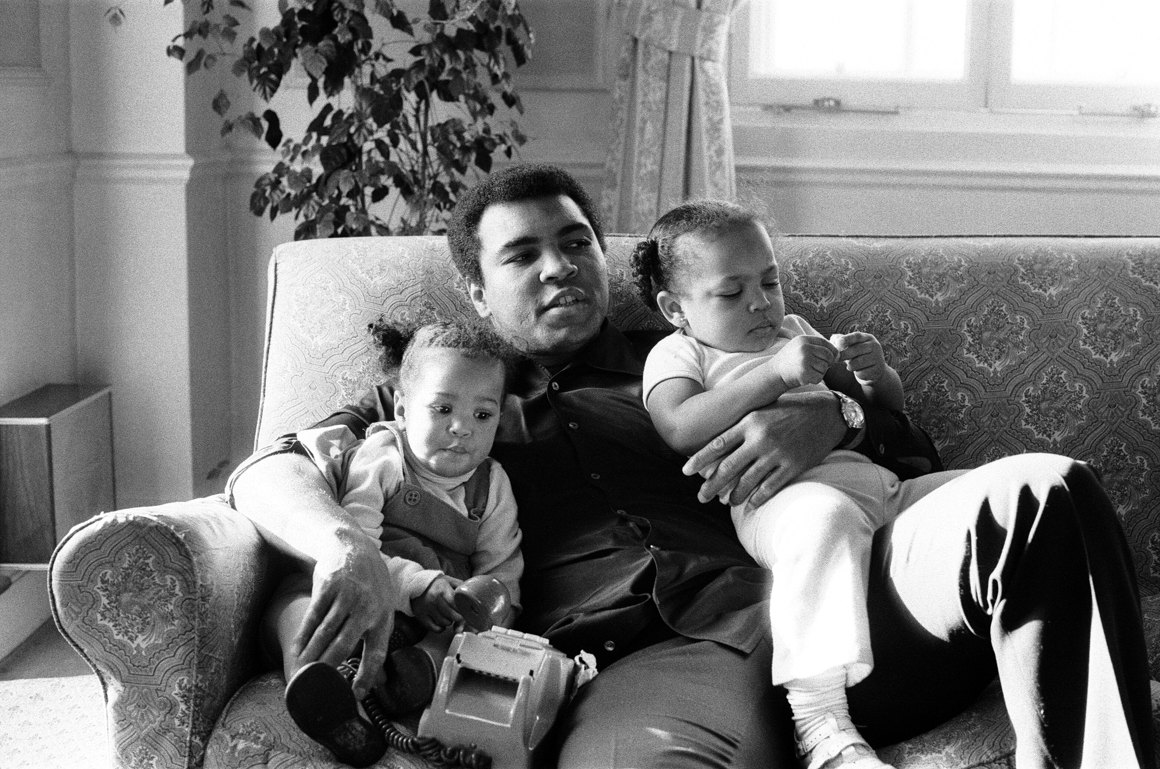  Muhammad Ali cuddling his daughters Laila, (L )and Hana (R) at a Hotel in London