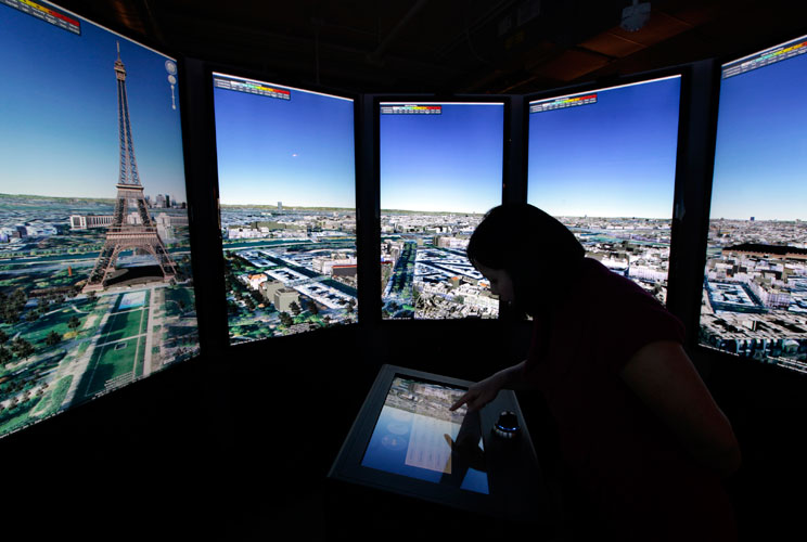 Katharine Ng zooms in to Paris on panoramic Google Maps screens at the campus.