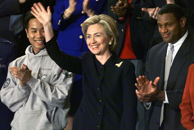 First lady Hillary Clinton responds to a standing ovation from a joint session of Congress before [President Bill Clinton&#039;s] State of the Union Address. Chicago Cubs&#039; star outfielder Sammy Sosa (at right) stands by the first lady. Clinton saluted Sosa for