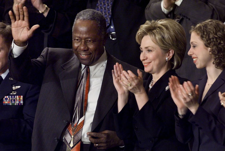 Baseball home run king Hank Aaron waves to members of Congress while next to U.S. first lady Hillary Clinton and daughter, Chelsea, after being introduced by President Bill Clinton during the State of the Union address. &quot;From his days as our all-time home
