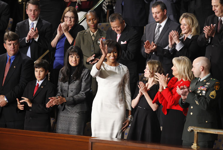 First lady Michelle Obama is applauded at her box during President Barack Obama's State of the Union address to a joint session of Congress on Capitol Hill in Washington, January 25, 2011. At far right is Staff Sergeant Salvatore Giunta, of Hiawatha, Iowa