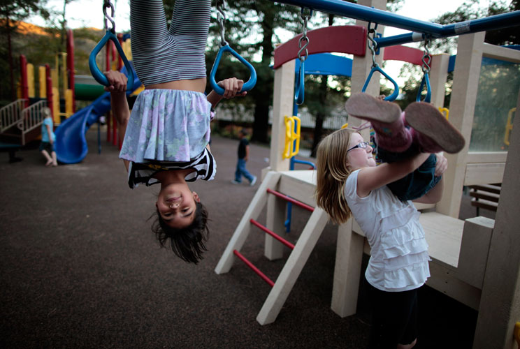 Lindzy Earp (2nd R), 10, plays in the playground.