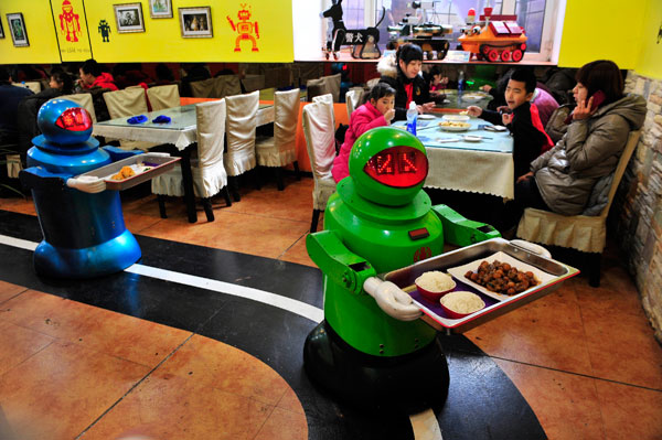 		<p>Robots deliver dishes to customers at a Robot Restaurant in Harbin, Heilongjiang province January 12, 2013. Opened in June 2012, the restaurant has gained fame in using a total of 20 robots, which range in heights of 4.27-5.25 ft, to cook meals and d