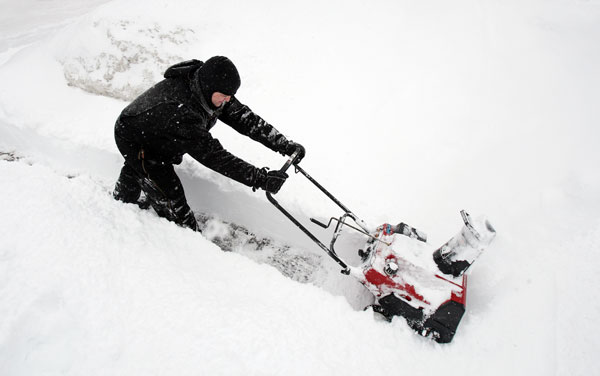 		&lt;p&gt;Shawn Shattuck uses a snowblower to clear a sidewalk after more than twelve inches of snow fell in Minneapolis, February 21, 2011.&lt;/p&gt;