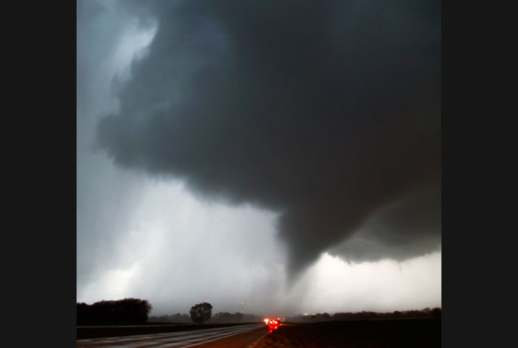 A tornado makes its way over the 135 freeway near Moundridge, Kansas, on April 14, the third day of severe weather and multiple tornado sightings. A spate of tornadoes tore through parts of Oklahoma, Kansas, Nebraska and Iowa, churning through Wichita and