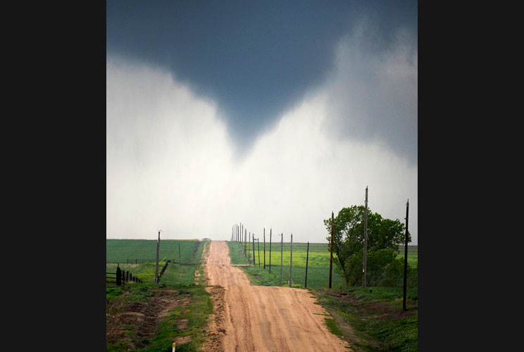 A tornado makes its way through farmlands near Rush Center, Kansas, on April 14.