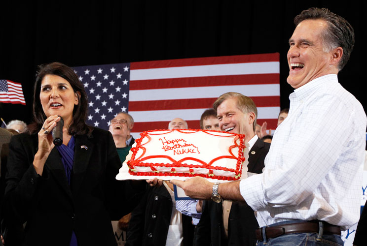 Mitt Romney presents a birthday cake to South Carolina Governor Nikki Haley during a campaign rally in North Charleston, South Carolina.