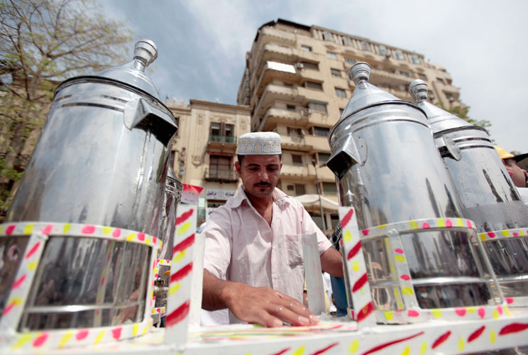 Waleed Ahmed el-Sayed, 31, who received a BA in social services from Assyiut University in 2004, sells juice in Tahrir square in Cairo May 4, 2012. Waleed has been working as a street vendor for almost seven years as he has not found a steady job since hi