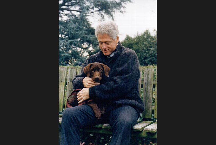 President Bill Clinton with his new three month old puppy, Buddy, in 1998.