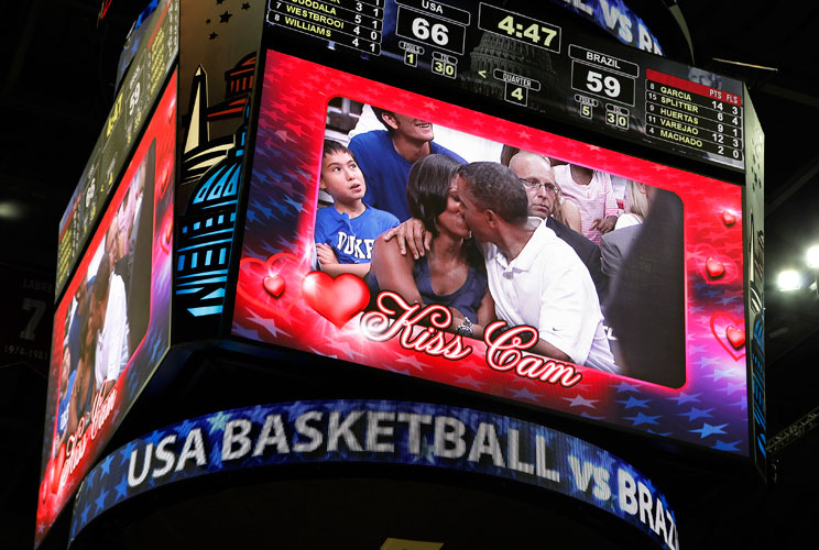 U.S. President Barack Obama and first lady Michelle Obama are shown kissing on the &quot;Kiss Cam&quot; screen during a timeout in the Olympic basketball exhibition game between the U.S. and Brazil national men&#039;s teams in Washington, July 16, 2012.     