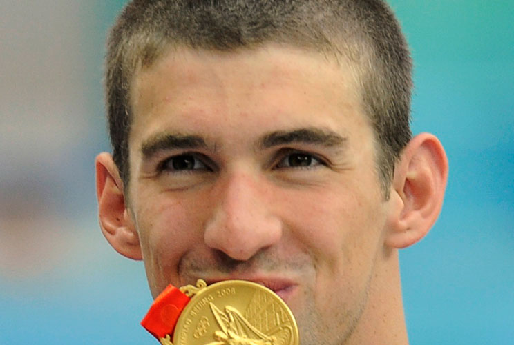 MICHAEL PHELPS GOLD MEDAL - 2nd of 8Michael Phelps of the U.S. kisses his second gold medal after the men's 4x100m freestyle relay swimming final at the National Aquatics Center during the Beijing 2008 Olympic Games August 11, 2008. Phelps swam his way in