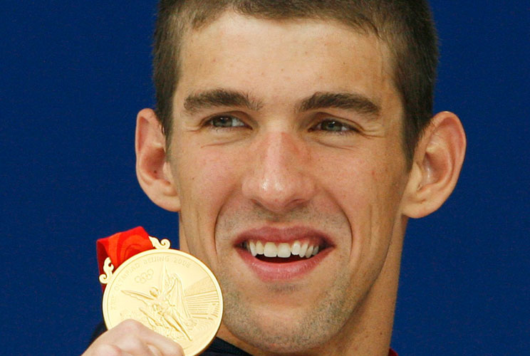 MICHAEL PHELPS GOLD MEDAL - 5th of 8Michael Phelps of the U.S. holds up his gold medal after the U.S. won the men's 4 x 200 meters freestyle relay swimming final during the Beijing 2008 Olympic Games at the National Aquatics Center, August 13, 2008. Phelp