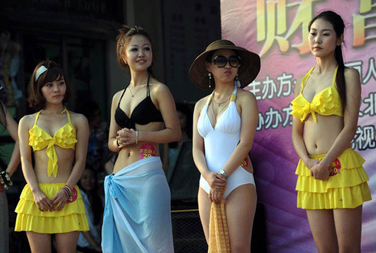 Chinese women parade in their swimsuits during a matchmaking event for wealthy men.