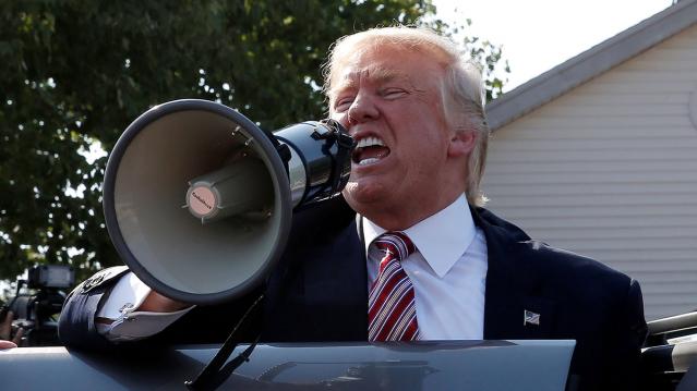 Republican presidential nominee Donald Trump speaks to supporters through a bullhorn during a campaign stop at the Canfield County Fair in Canfield
