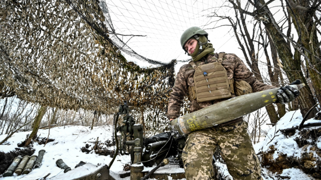 Soldier in Ukraine loading an American-made M777 howitzer