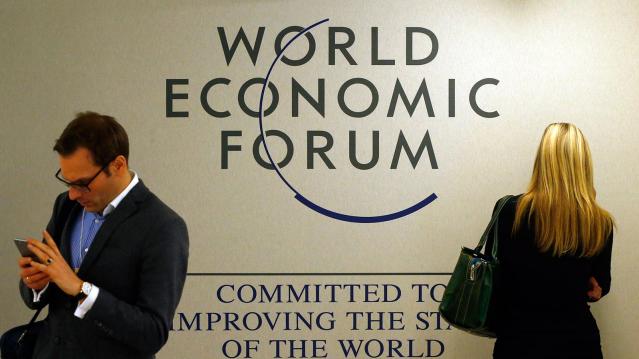 Attendees use their mobile device during the annual meeting 2016 of the WEF in Davos