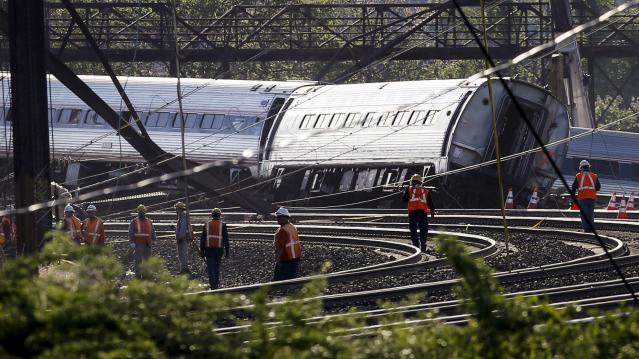 Officials survey the site of a derailed Amtrak train in Philadelphia, Pennsylvania 