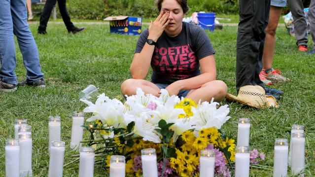 A local resident of Charlottesville cries at a vigil for the 19 people injured and one killed when a car plowed into counter protesters near the &quot;Unite the Right&quot; rally organized by white nationalists in Charlottesville