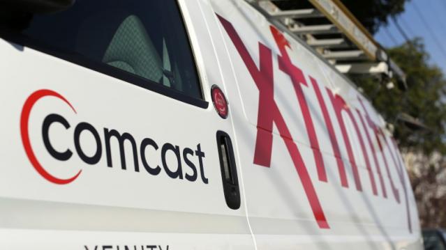 A Comcast sign is shown on the side of a vehicle in San Francisco, California February 13, 2014. REUTERS/Robert Galbraith  