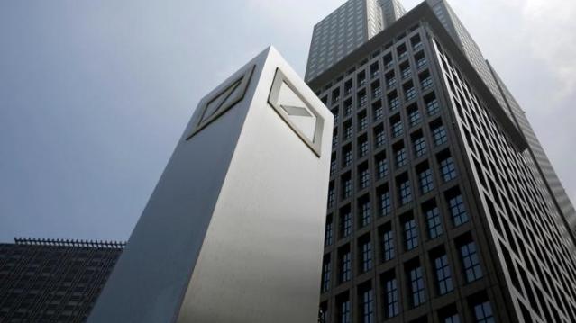 FILE PHOTO: Logos of Deutsche Bank AG are seen in Tokyo July 16, 2014. REUTERS/Toru Hanai/File Photo      