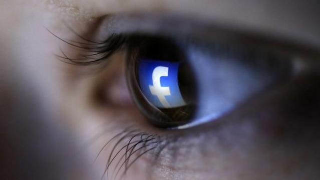 A picture illustration shows a Facebook logo reflected in a person&#039;s eye, in Zenica, March 13, 2015. REUTERS/Dado Ruvic