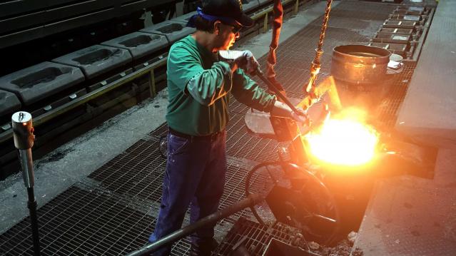 Martin Rangel, a worker at Bremen Castings, pours motel metal into forms on the foundry’s production line in Bremen
